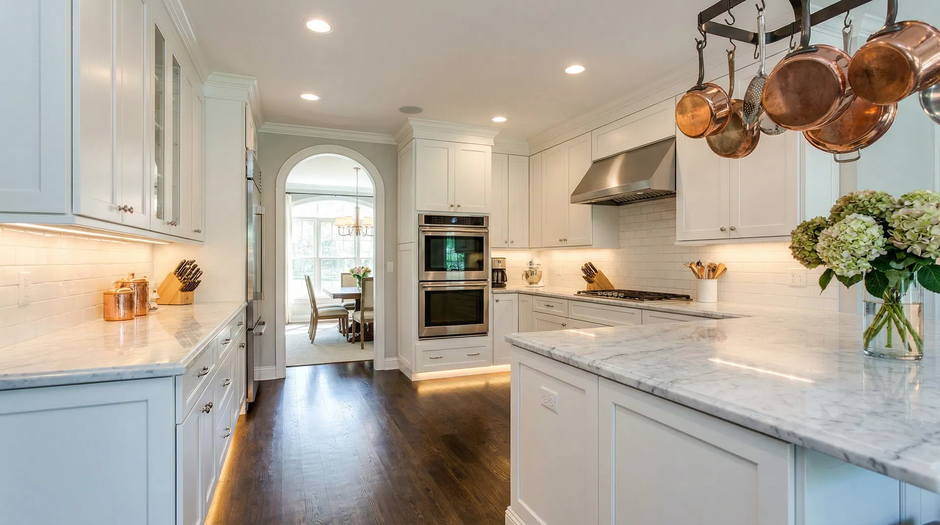 White shaker kitchen cabinets with marble countertops installed by Bear Cabinetry