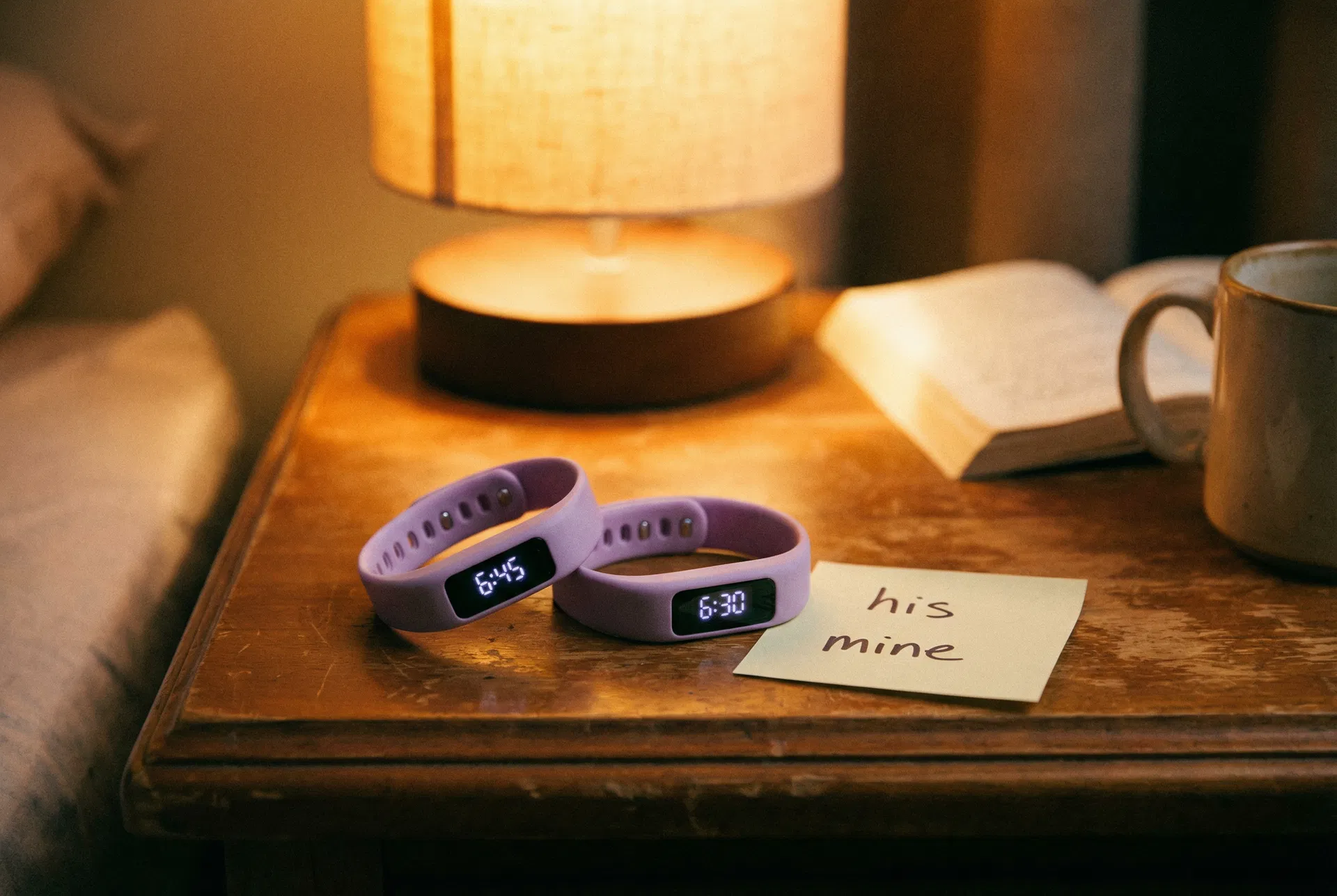 Two lavender CalmRise wristbands on a nightstand labeled 'his' and 'mine'