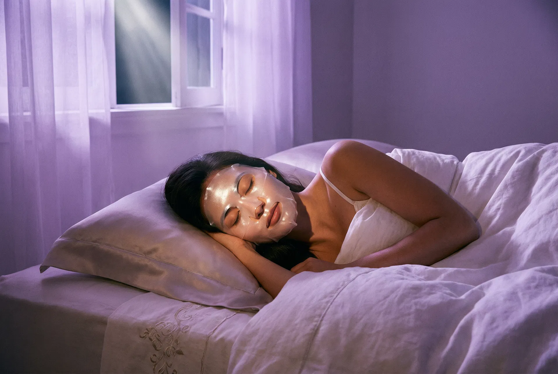 Woman sleeping peacefully with hydrogel mask in purple ambient light