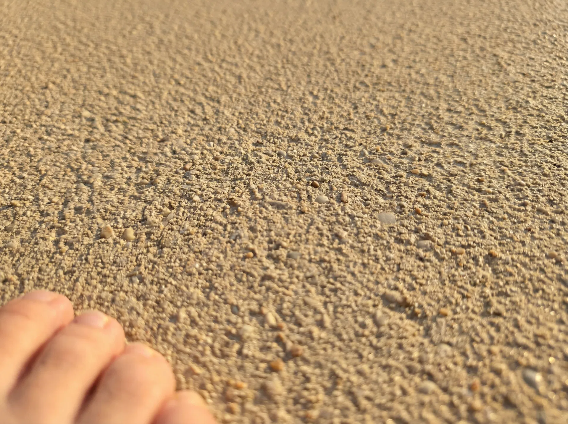 Hot concrete pool deck before cool deck coating