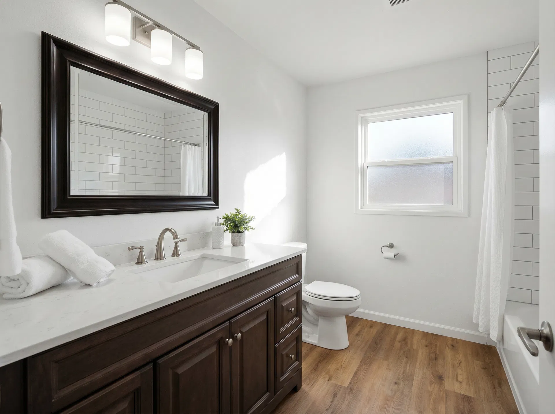 Bathroom — new vanity, tile surround, modern fixtures, LVP floor — After