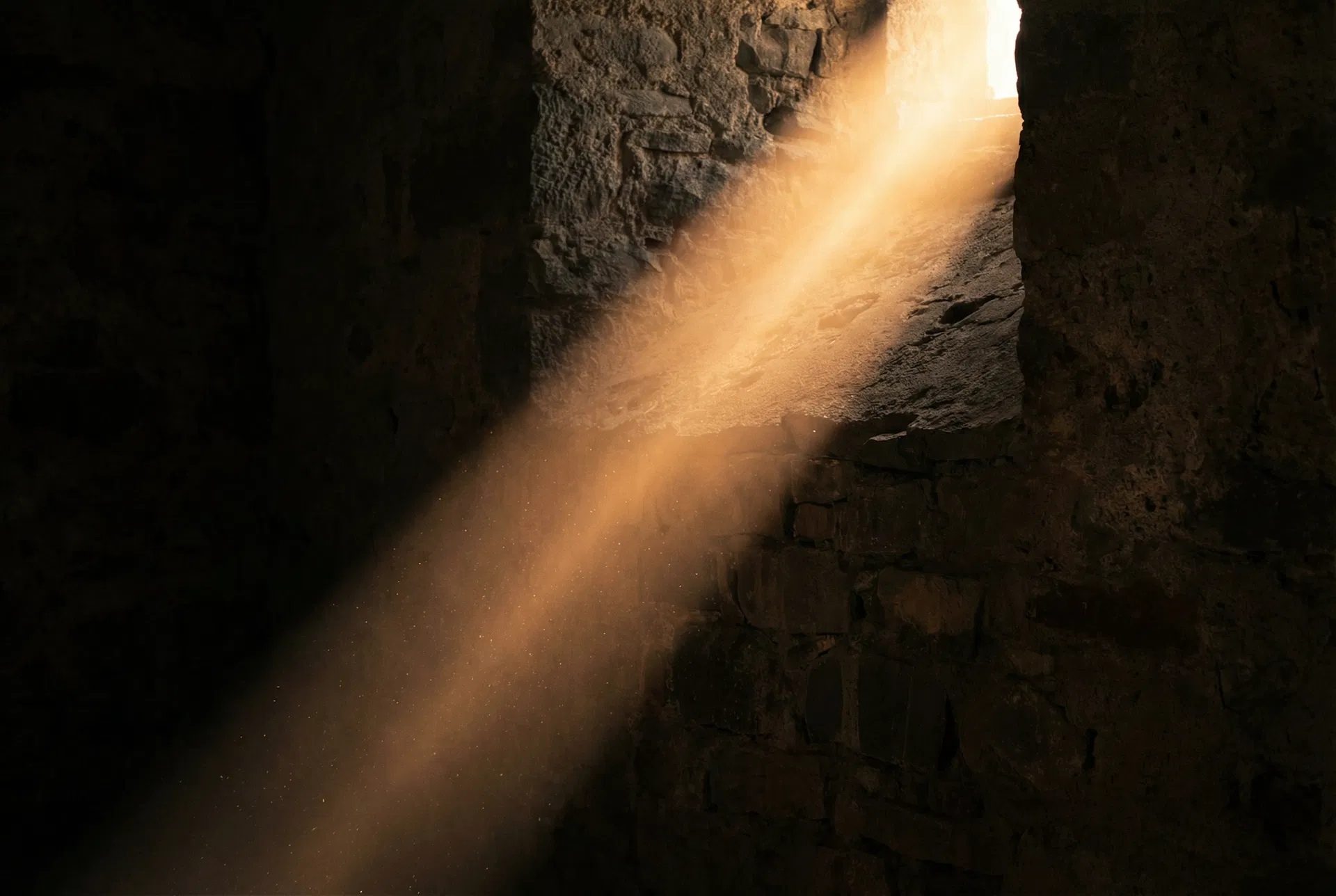 A beam of golden light piercing through darkness — a metaphor for hope