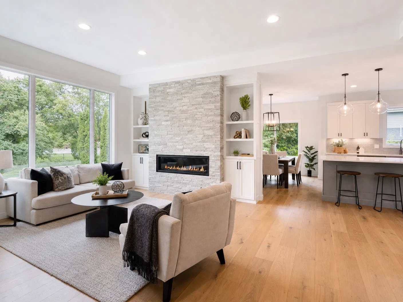 Completely renovated open-concept main floor with stone fireplace and hardwood floors