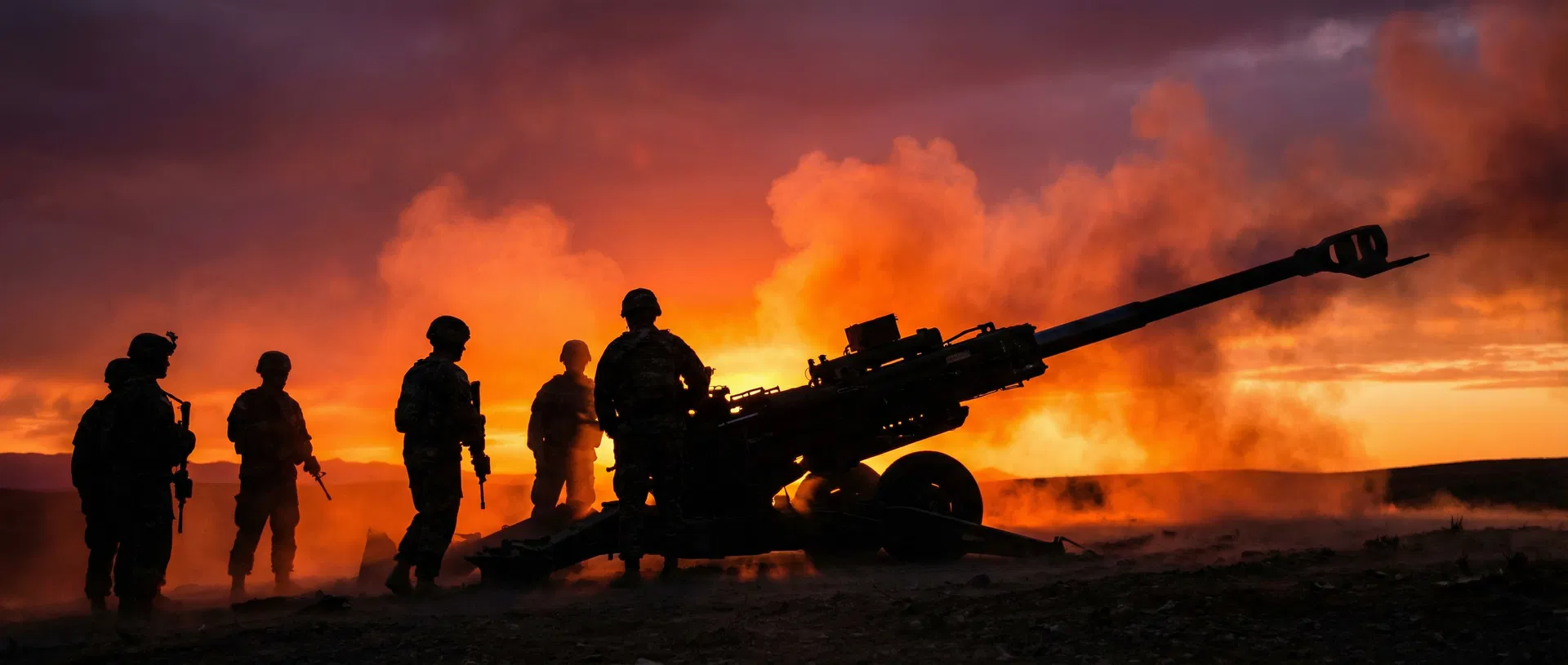 Artillery soldiers silhouetted against fiery sunset