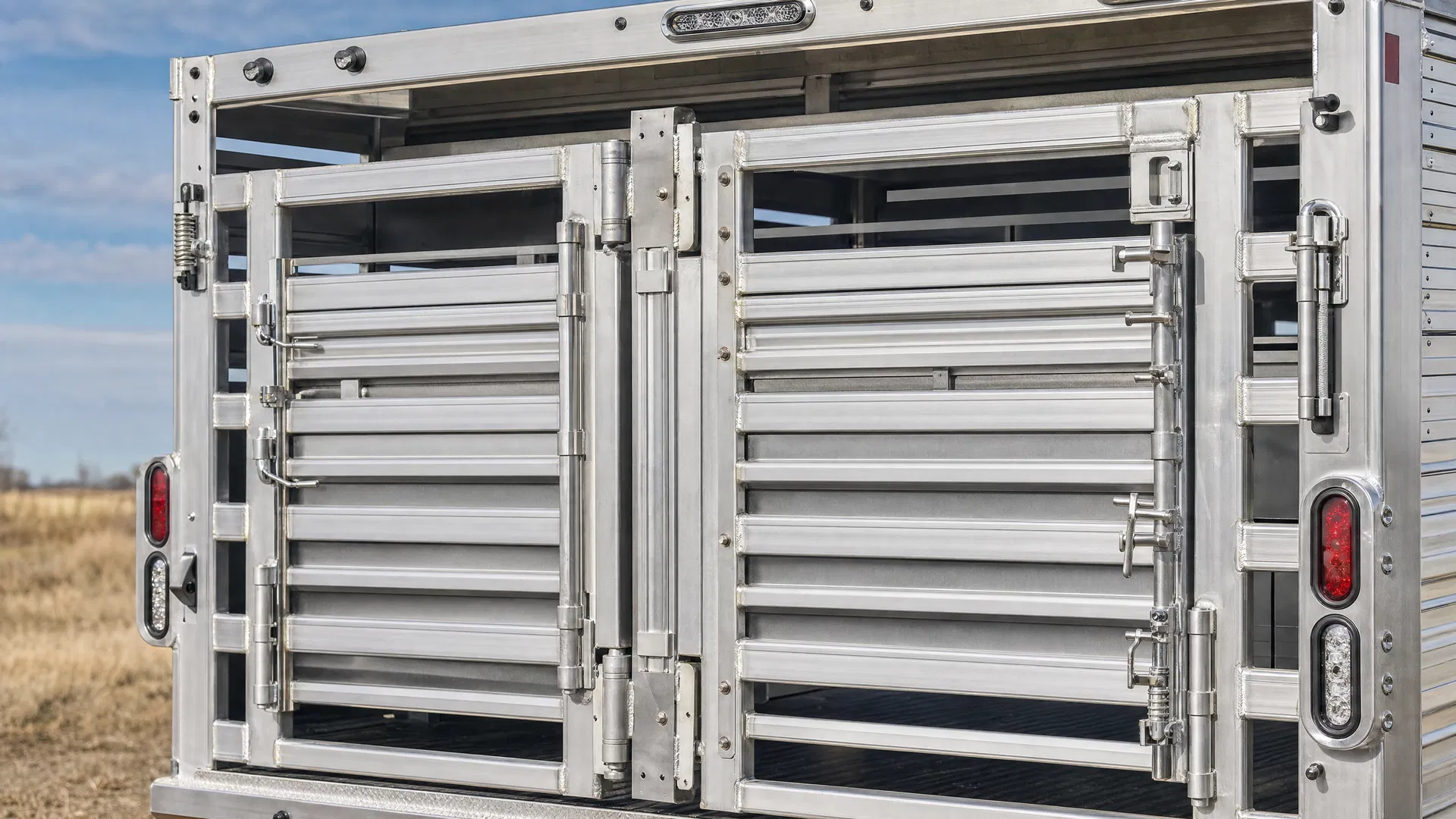 Heavy-duty trailer gate system with butterfly gates