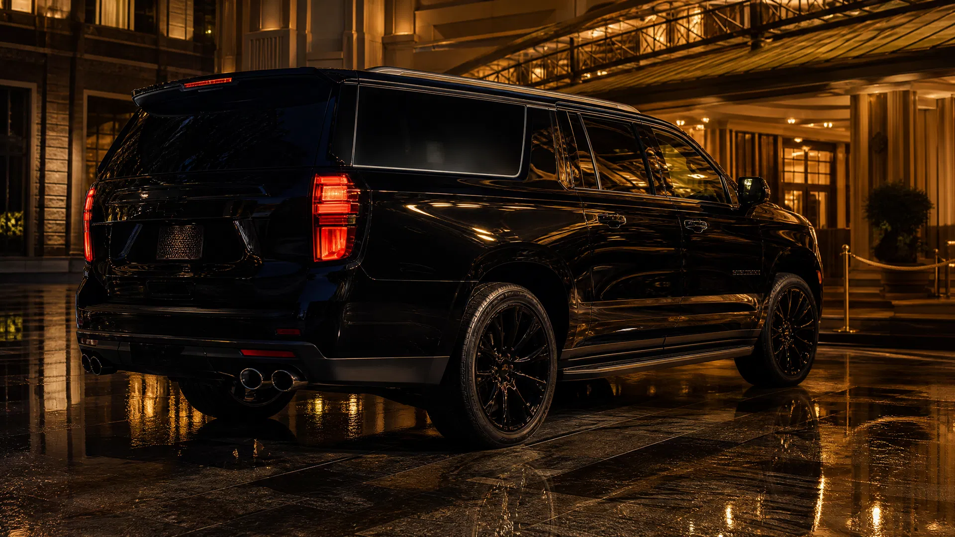Black Chevrolet Suburban rear at luxury hotel — VIP car service Connecticut