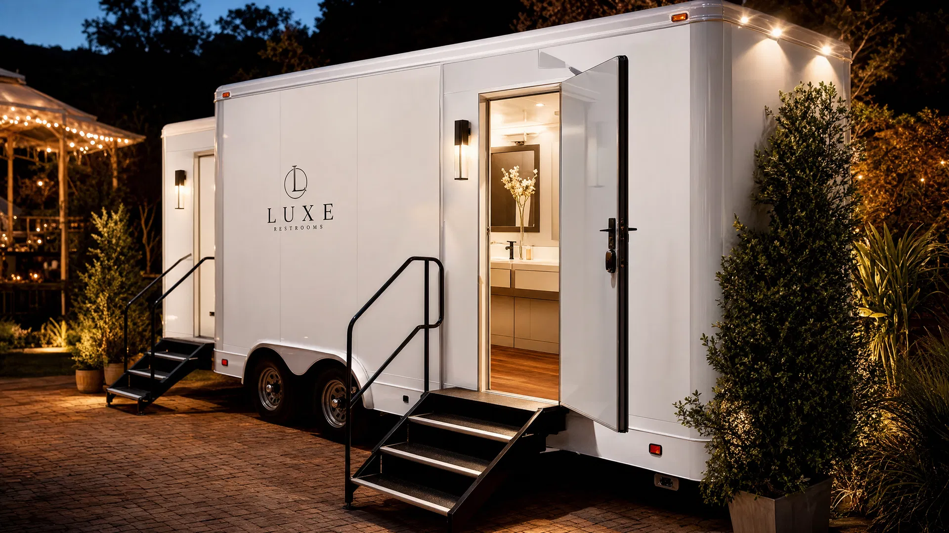 Luxury portable restroom trailer interior showing wood floors, porcelain sink, and clean design