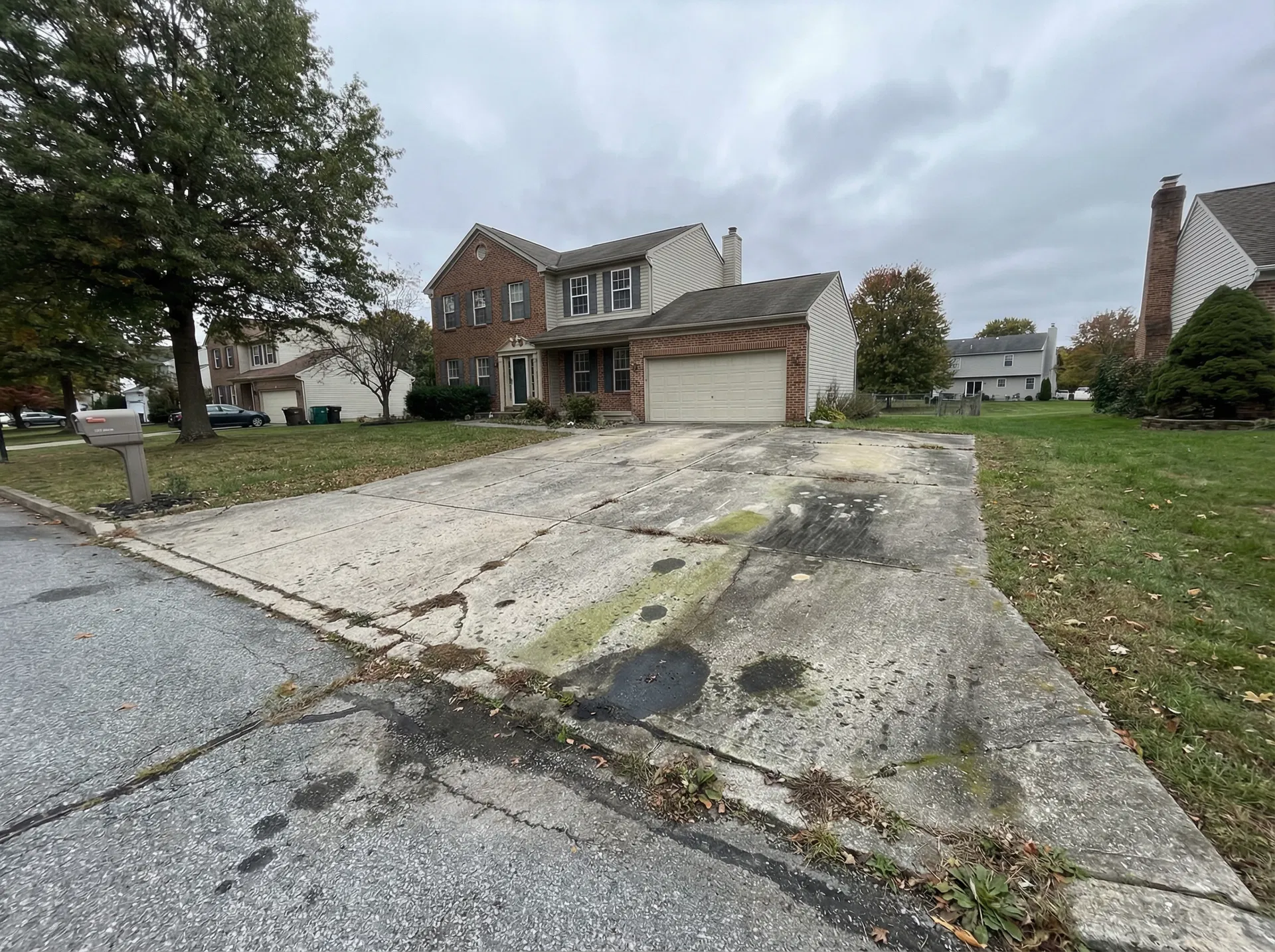 Dirty stained concrete driveway before power washing in Doylestown PA