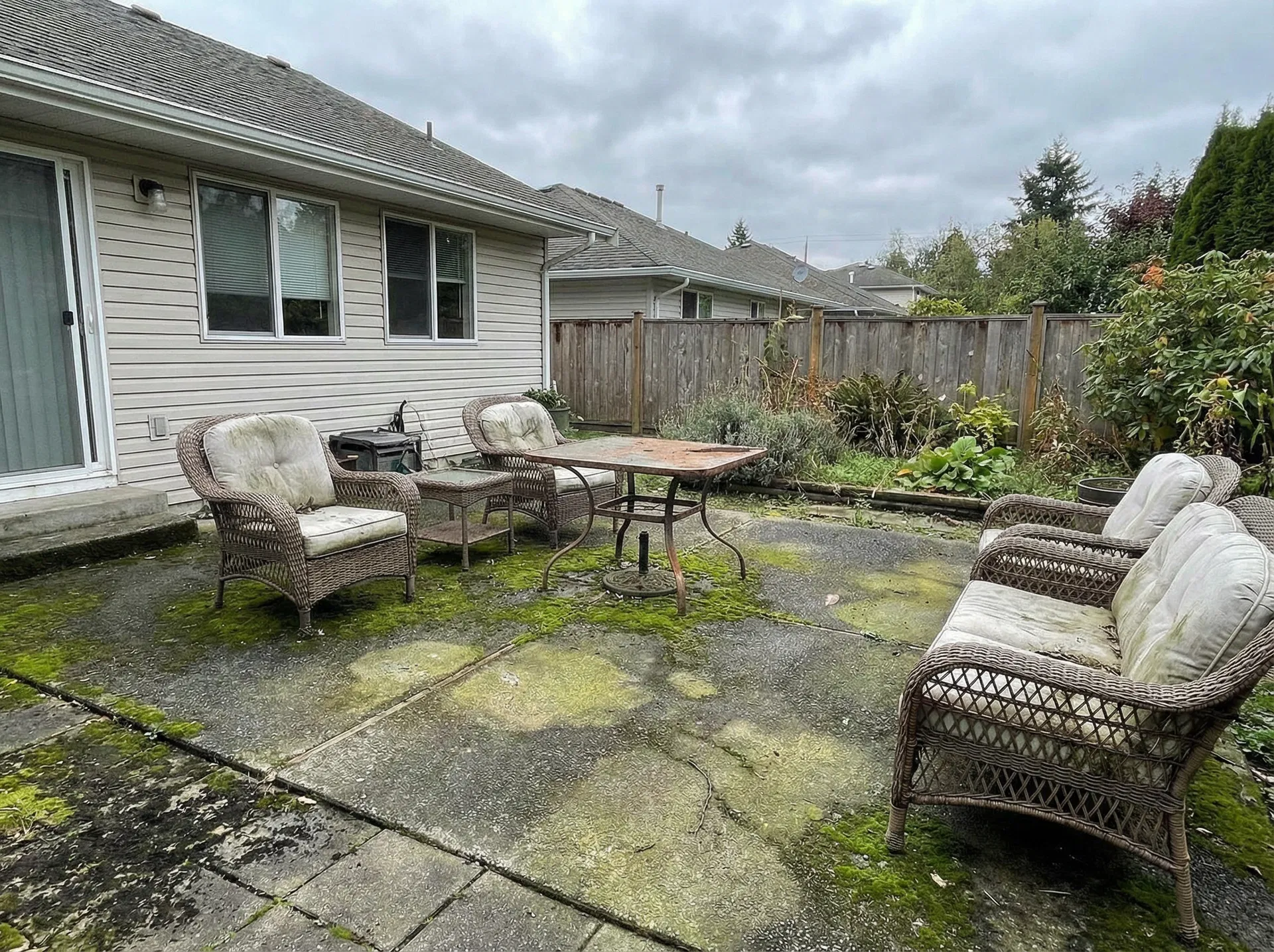 Dirty concrete patio covered in algae before power washing in Horsham PA
