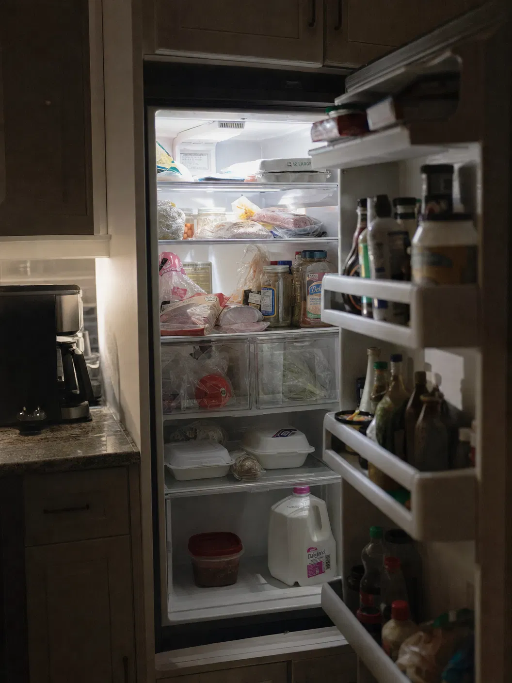 Interior of a modern American refrigerator under cold fluorescent light