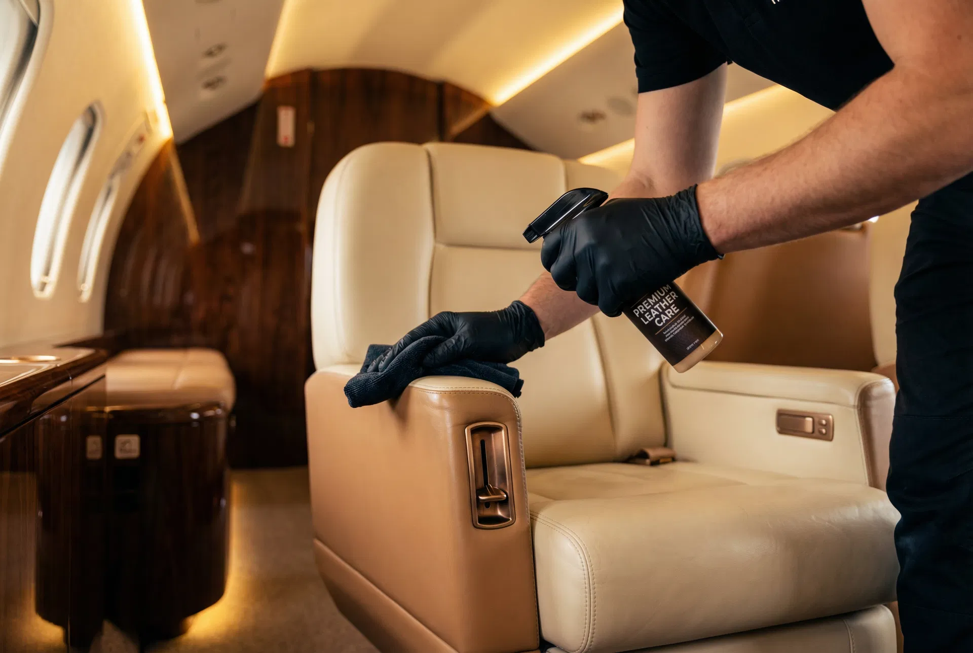 Technician restoring leather seats inside a private jet