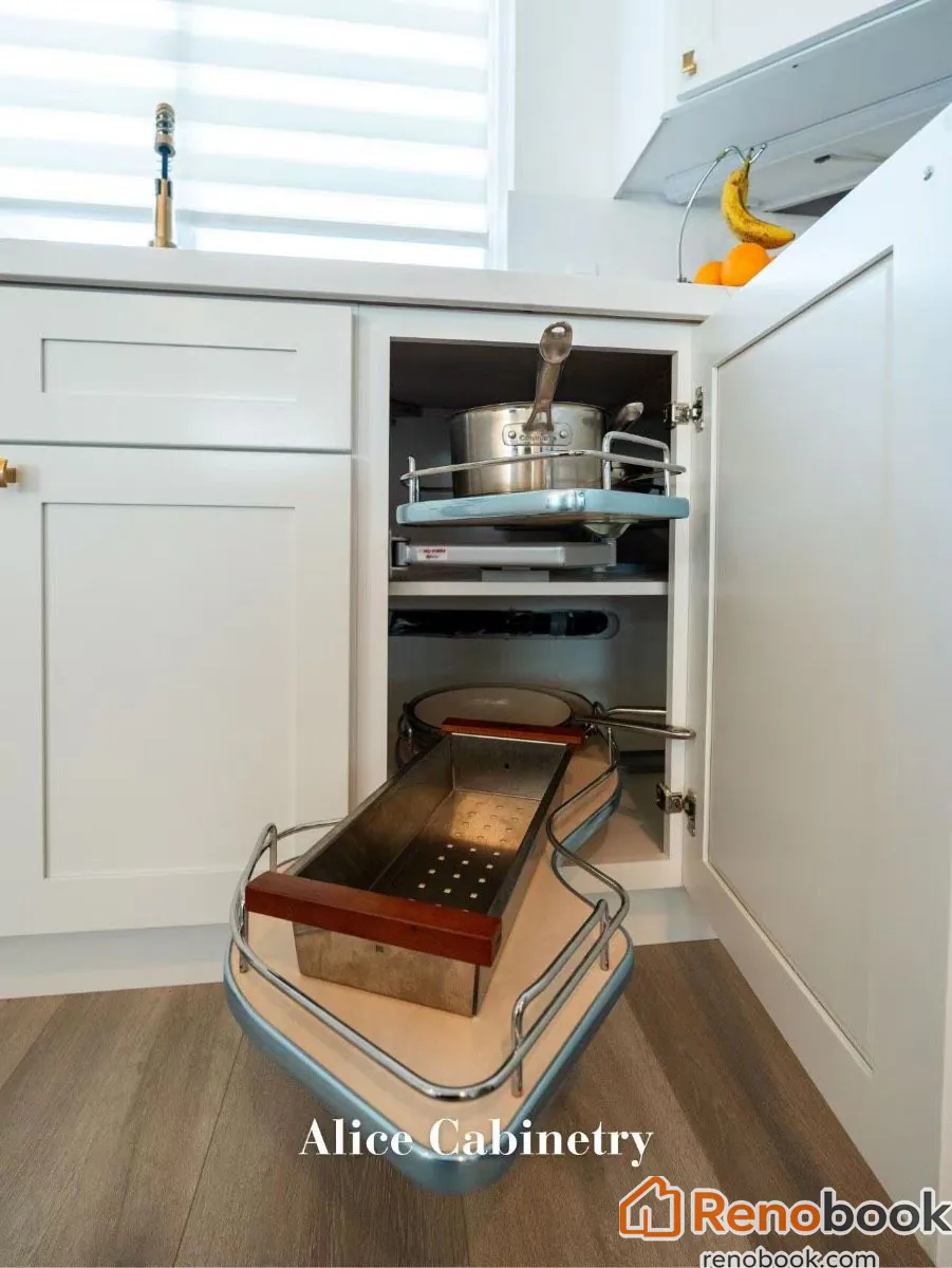 Modern kitchen with navy island, white quartz waterfall countertop, and gold accents in San Leandro, CA, USA