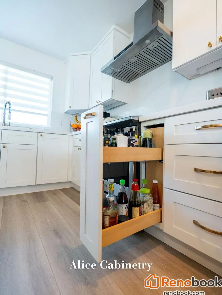 Modern kitchen with navy island, white quartz waterfall countertop, and gold accents in San Leandro, CA, USA