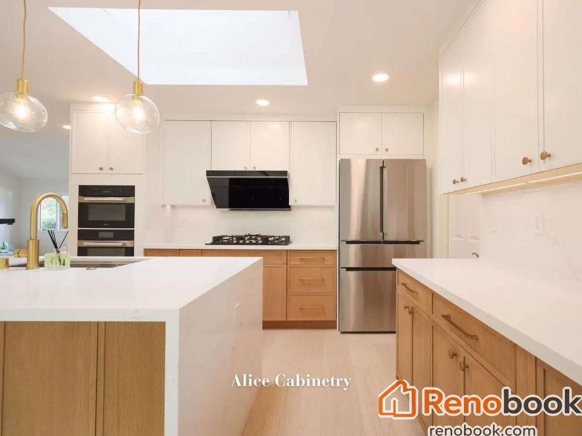 Modern two-tone kitchen with light wood cabinetry, quartz island, and skylights in San Leandro, CA, USA