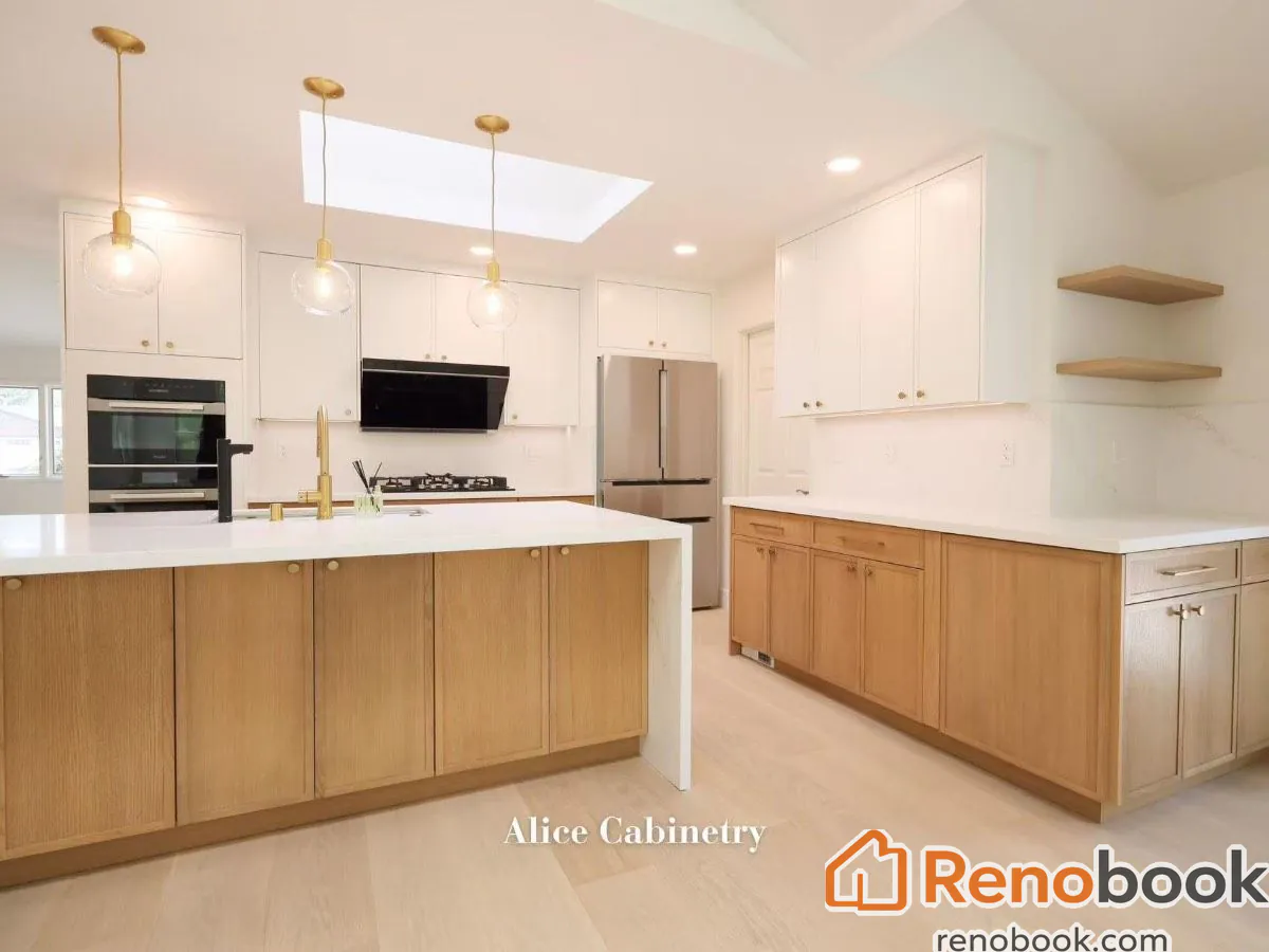 Modern two-tone kitchen with light wood cabinetry, quartz island, and skylights in San Leandro, CA, USA