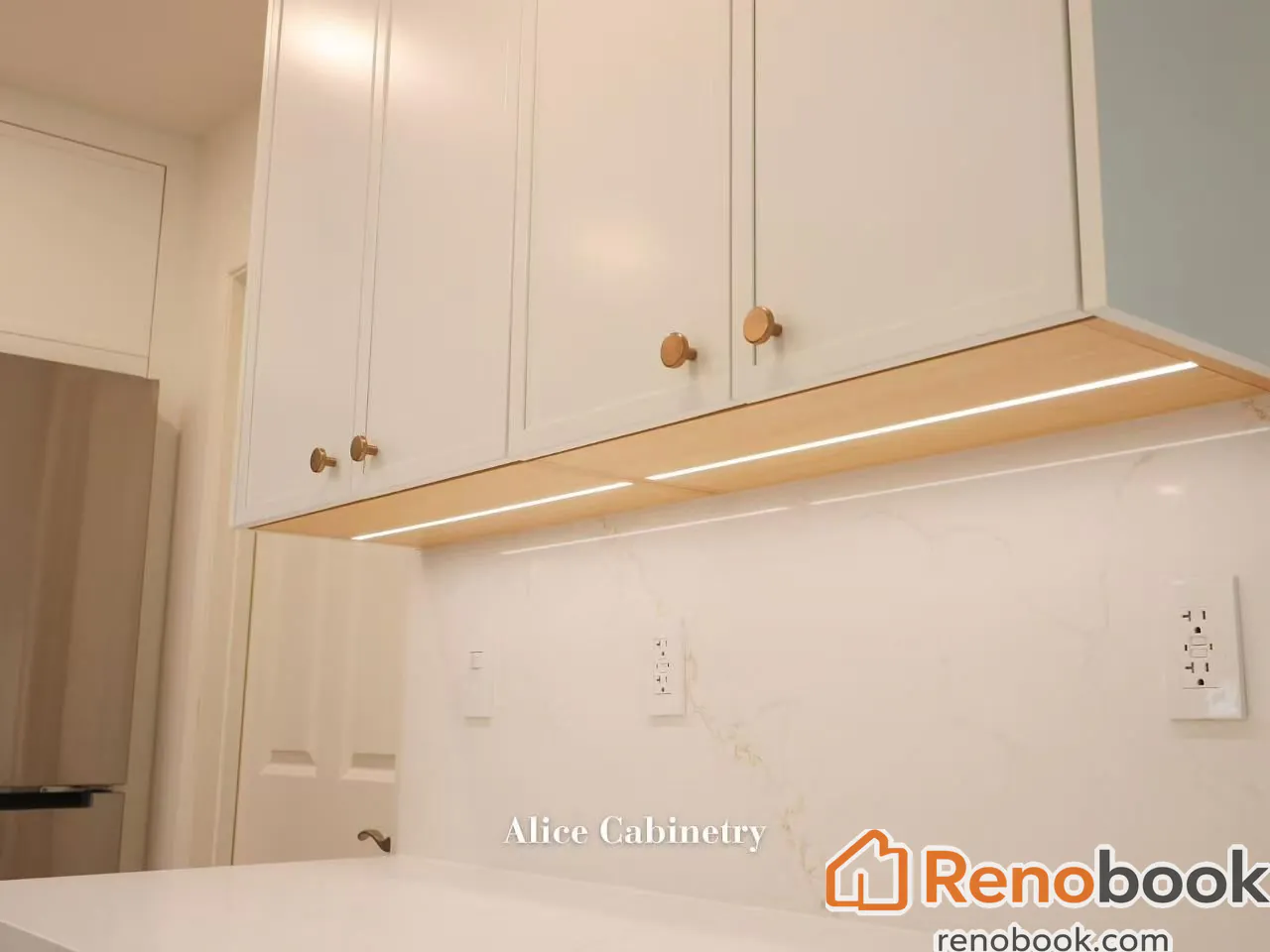 Modern two-tone kitchen with light wood cabinetry, quartz island, and skylights in San Leandro, CA, USA