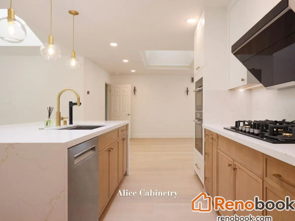 Modern two-tone kitchen with light wood cabinetry, quartz island, and skylights in San Leandro, CA, USA