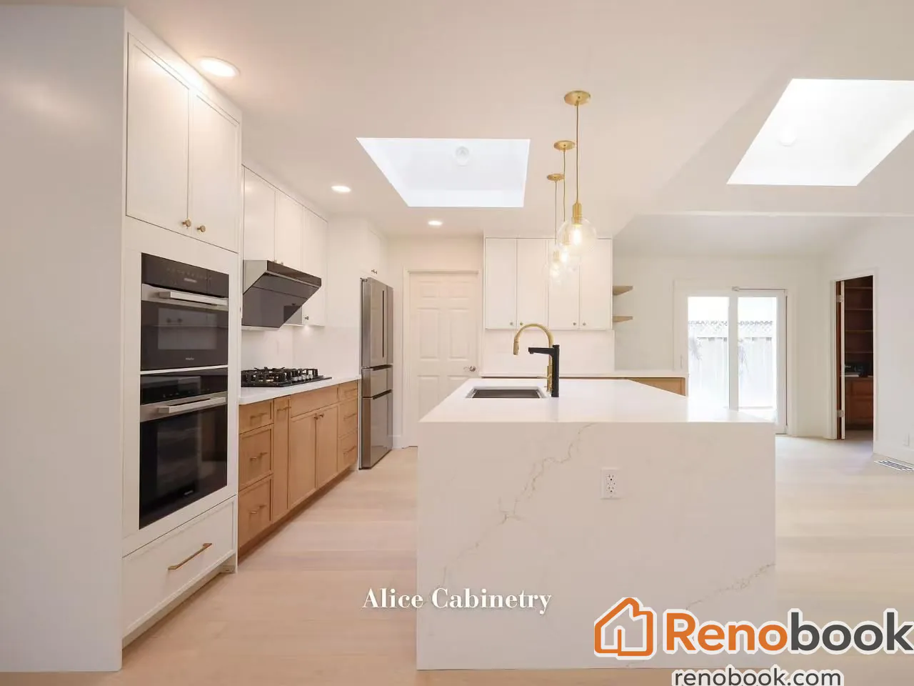 Modern two-tone kitchen with light wood cabinetry, quartz island, and skylights in San Leandro, CA, USA