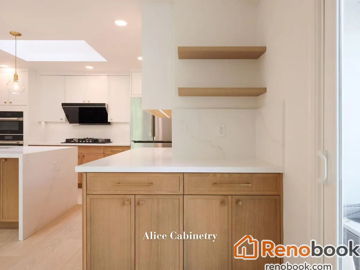 Modern two-tone kitchen with light wood cabinetry, quartz island, and skylights in San Leandro, CA, USA
