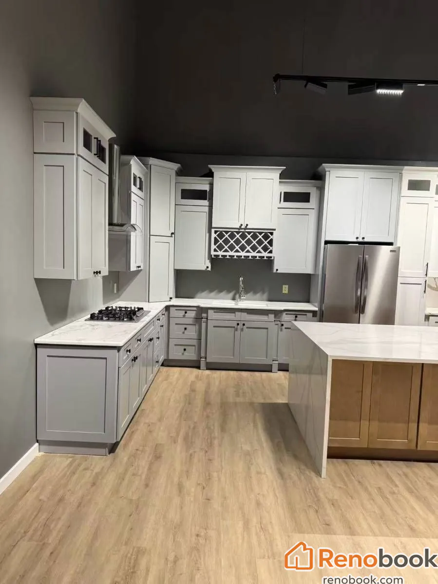 Two-tone shaker kitchen with gray and white cabinets, quartz counters, and island in Pomona, CA, USA