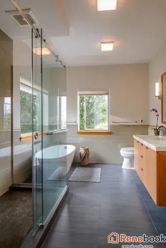 Modern bathroom with freestanding tub, glass shower, and floating wood vanity in Menlo Park, CA, USA