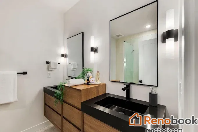 Modern double vanity bathroom with wood cabinets & black integrated sinks in Menlo Park, CA, USA