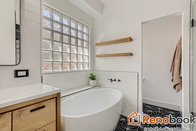 Modern bathroom with freestanding tub, glass block window & geometric floor in Las Vegas, NV, USA