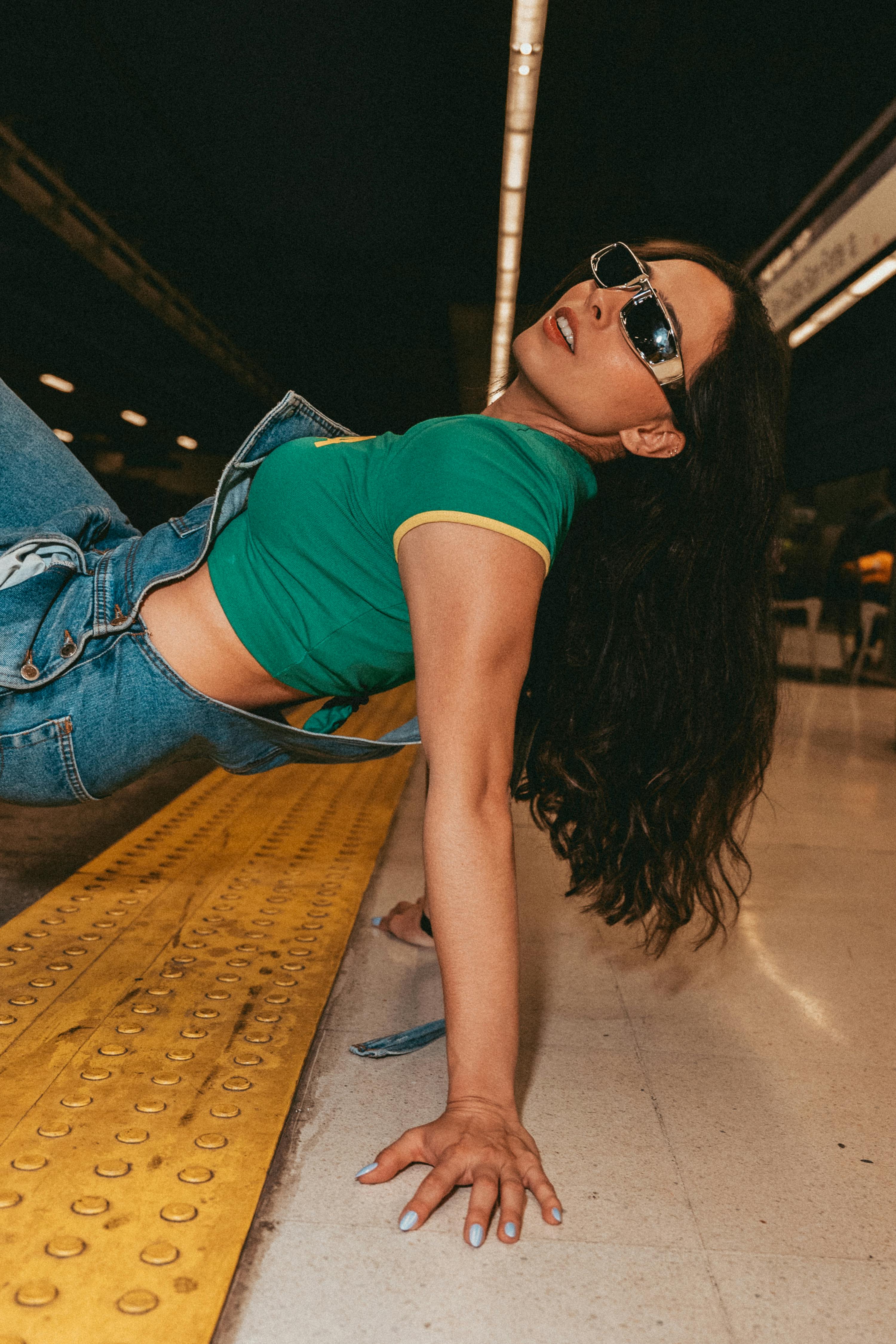 Young Woman Posing Dynamically on Subway Platform