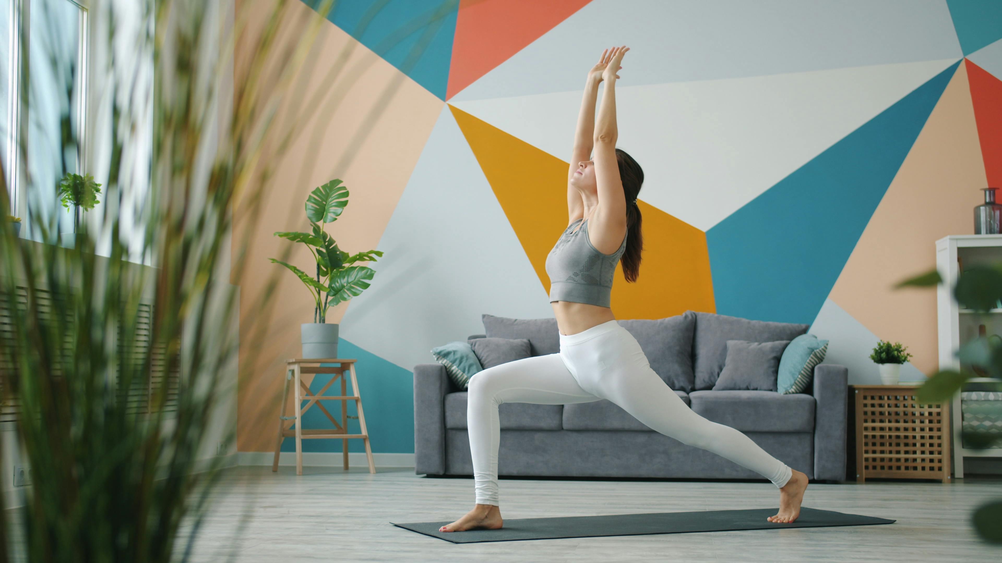 Woman practicing yoga in a colorful living room
