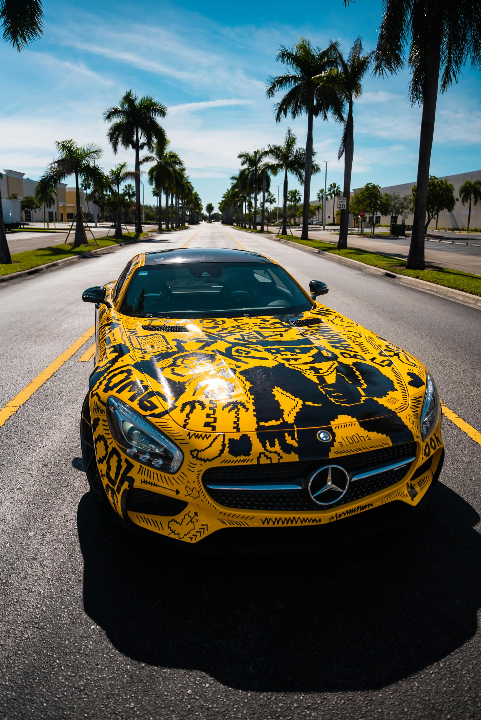 Yellow Mercedes Sports Car on Palm-Lined Road