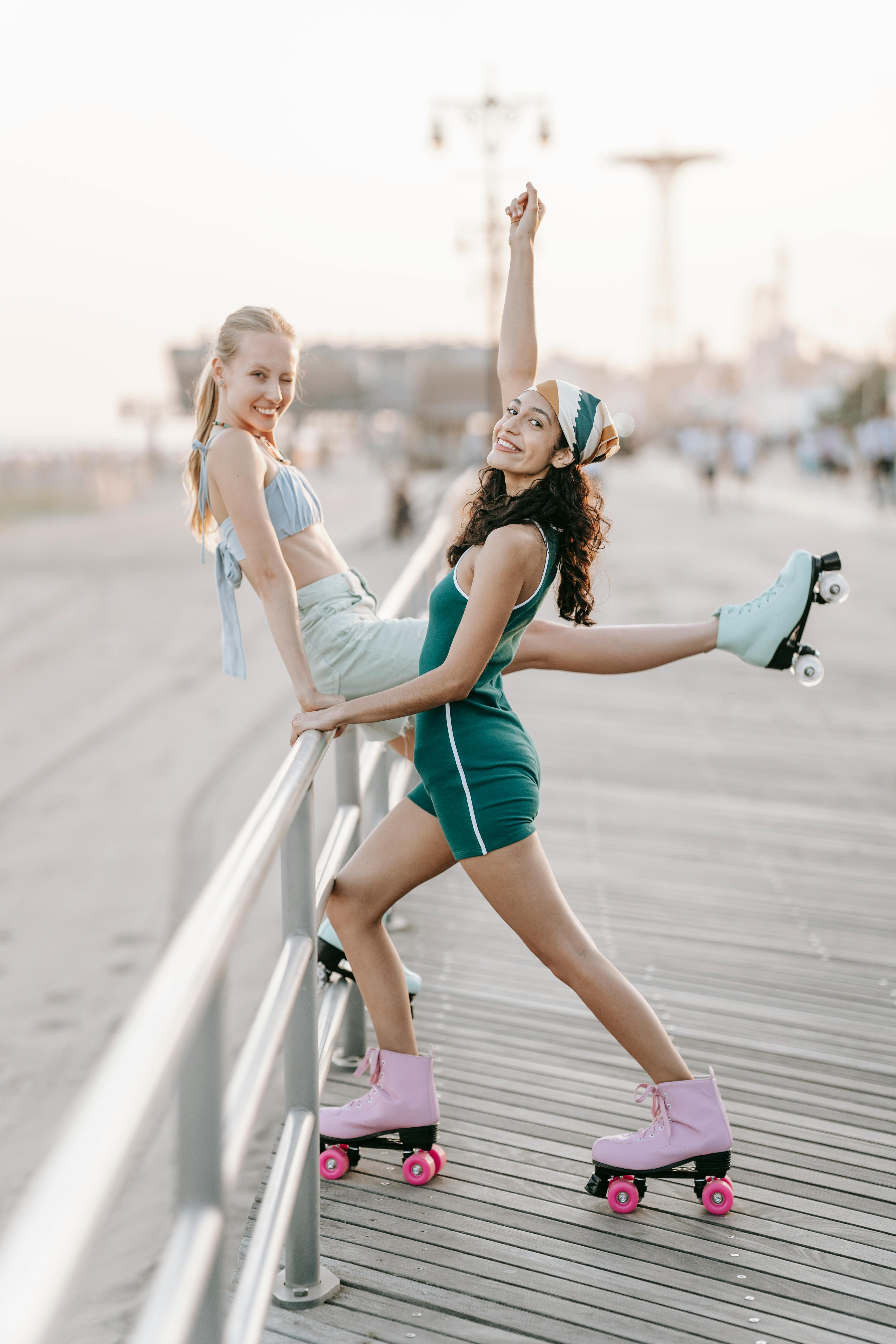Joyful Young Women Roller Skating on Boardwalk