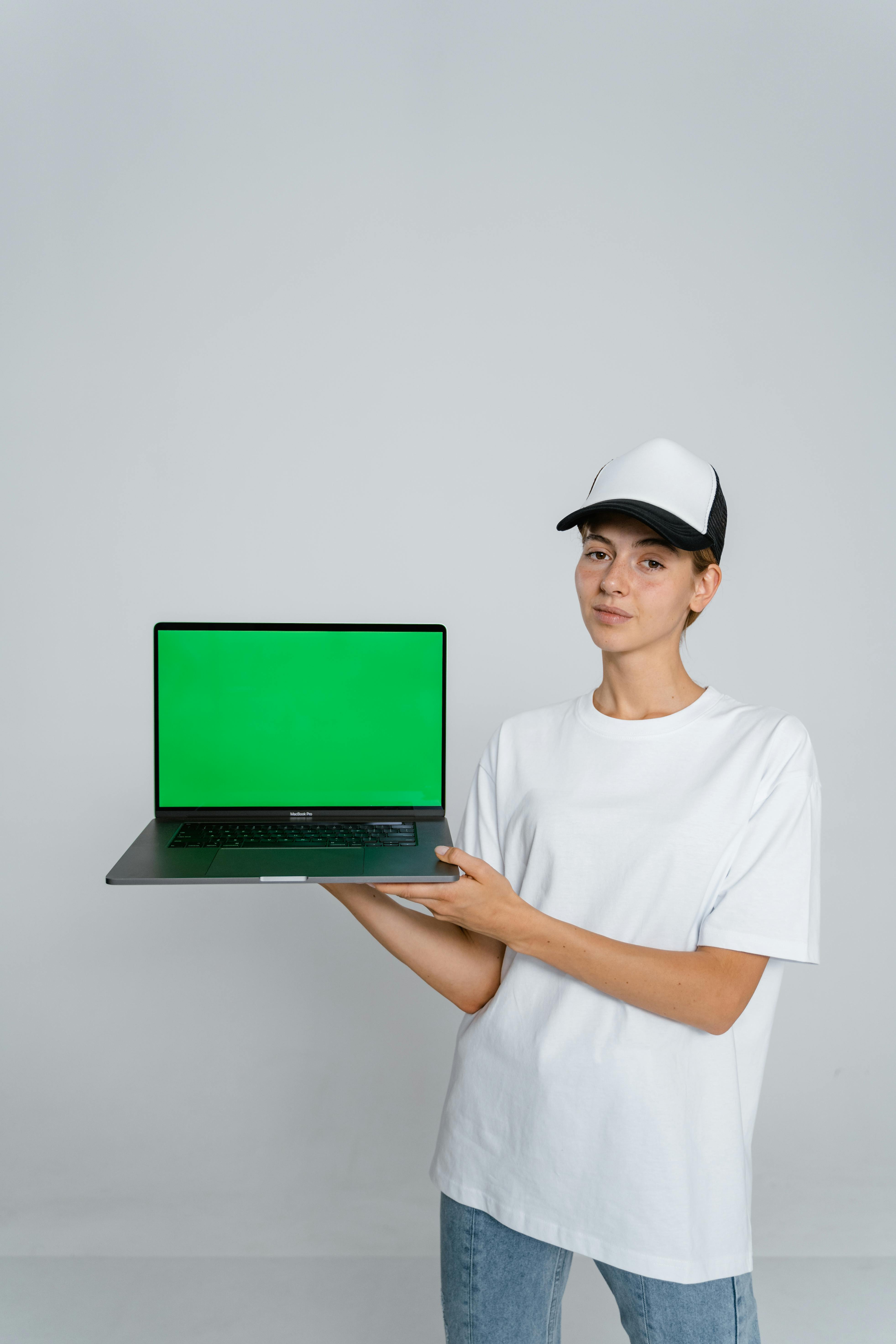 Young Woman Holding Laptop with Green Screen