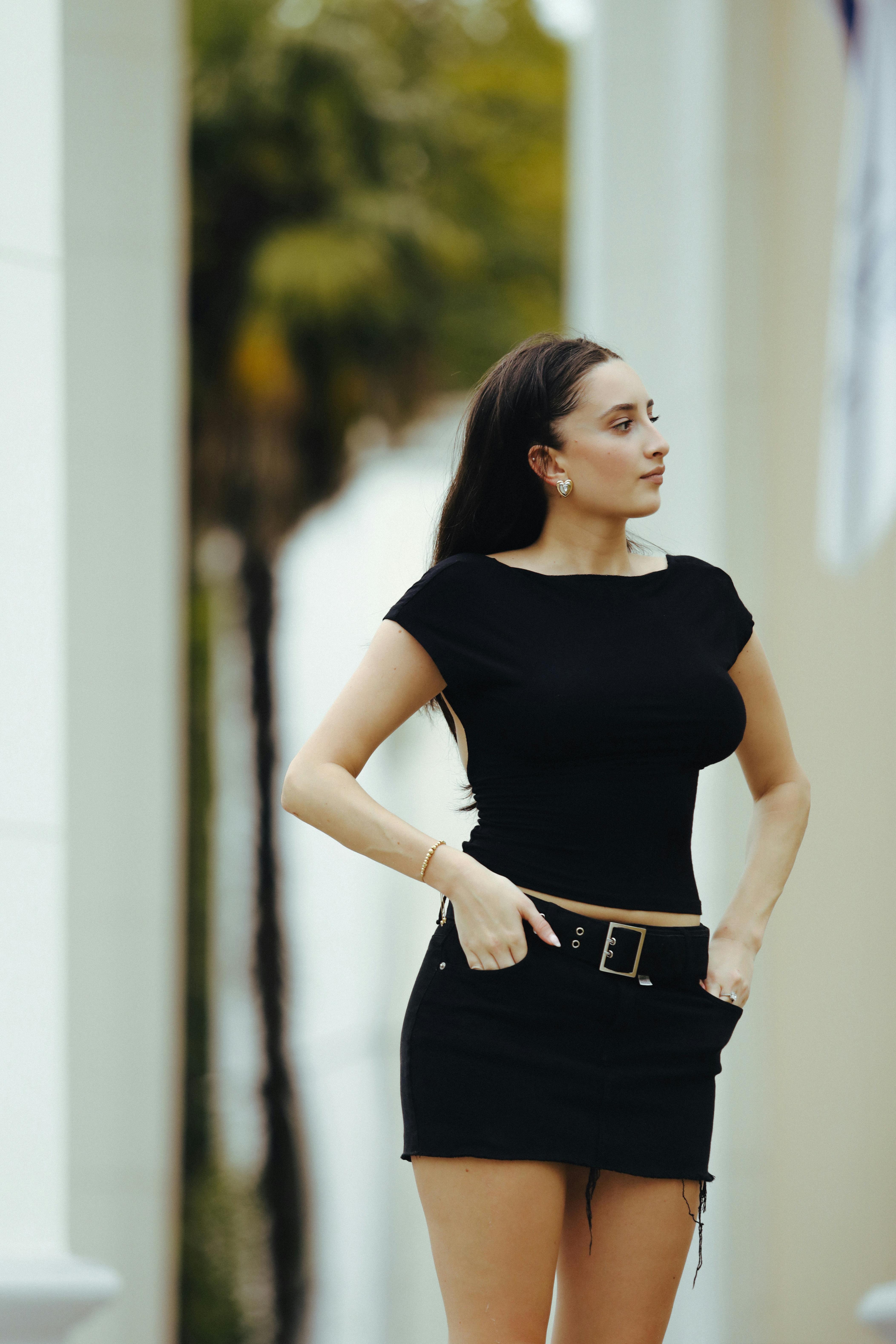 Young Woman in Black Outfit Posing Outdoors