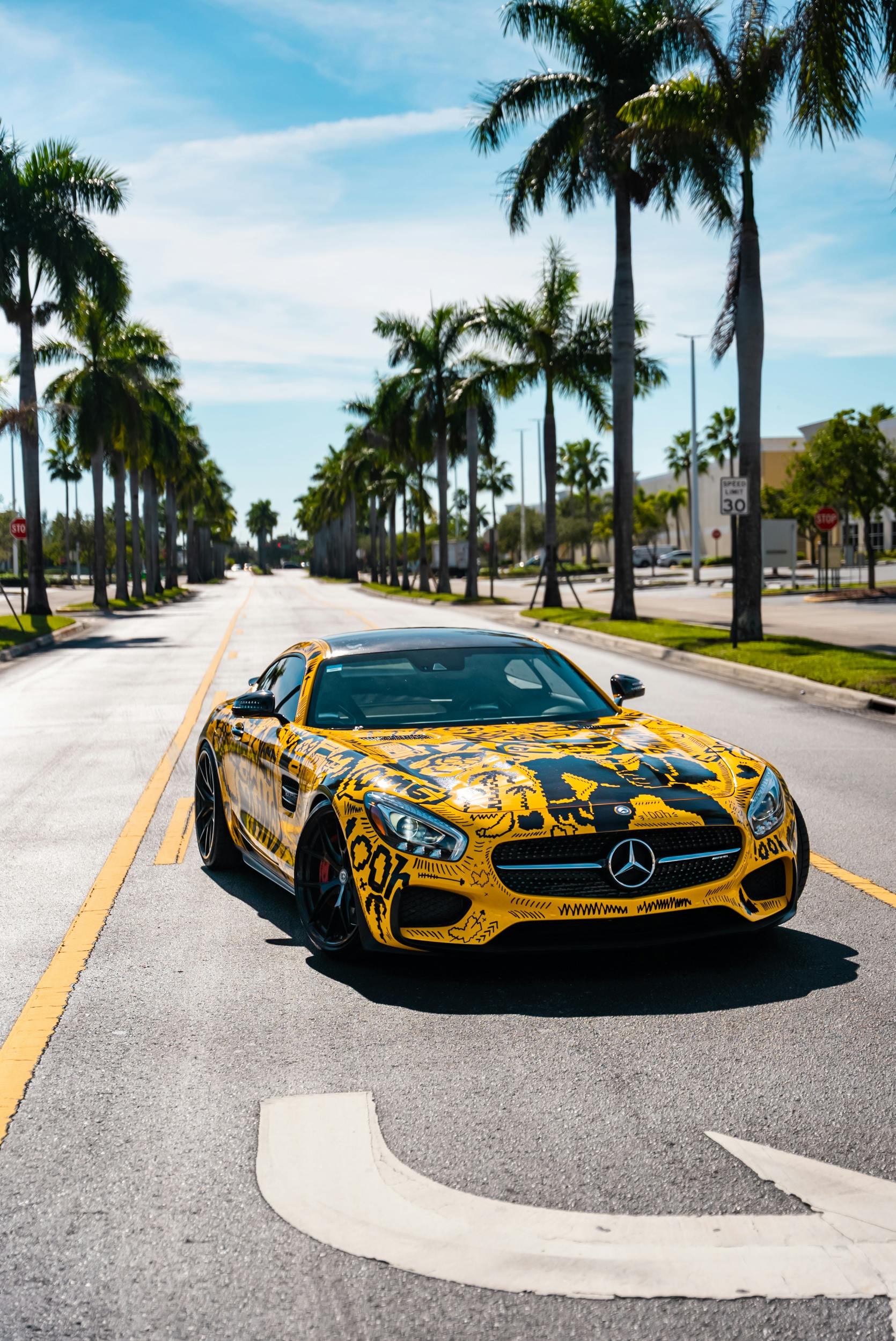 Yellow Mercedes-Benz Sports Car on Palm-Lined Street