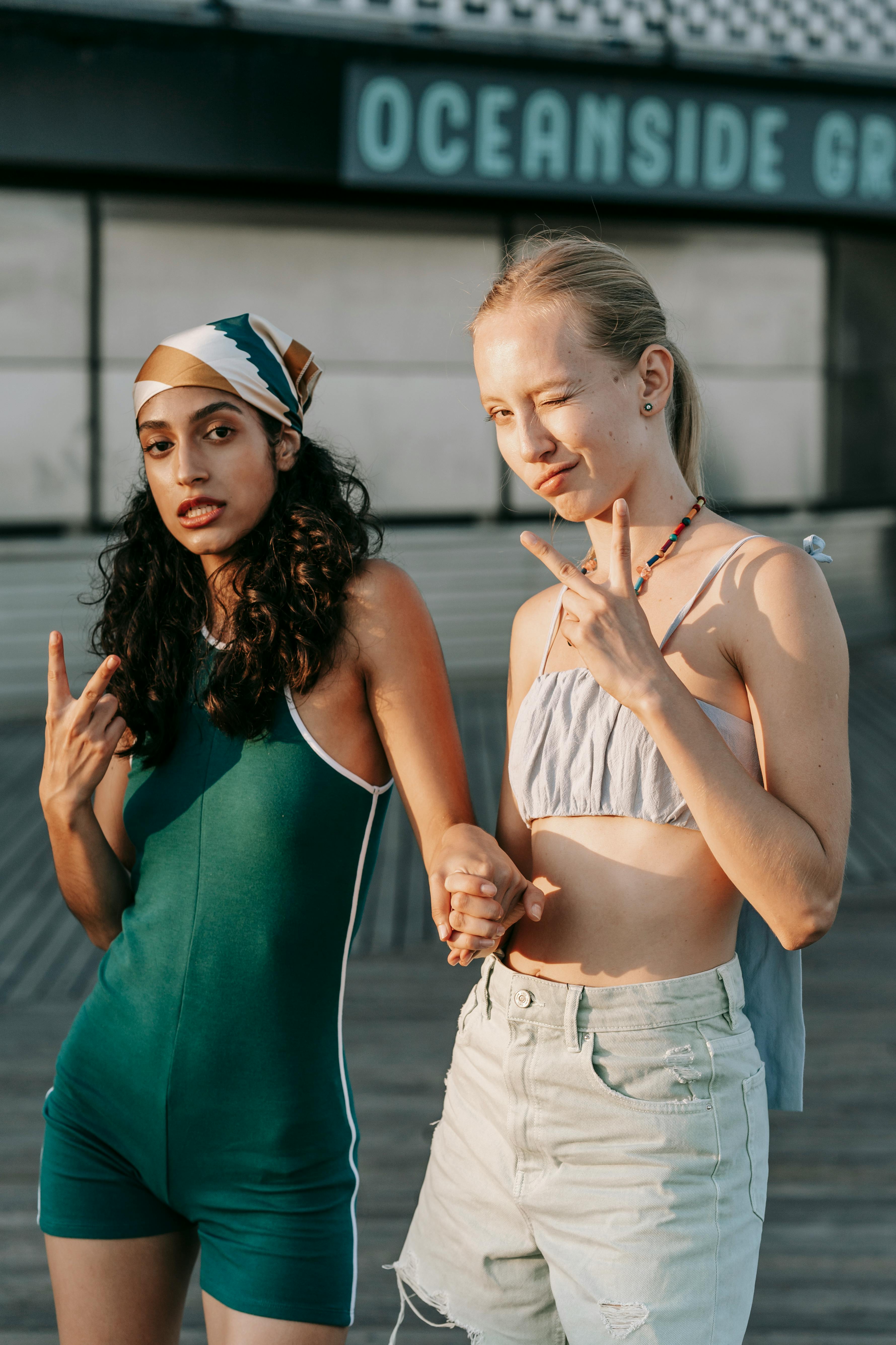 Two Young Women Posing on Oceanside Boardwalk
