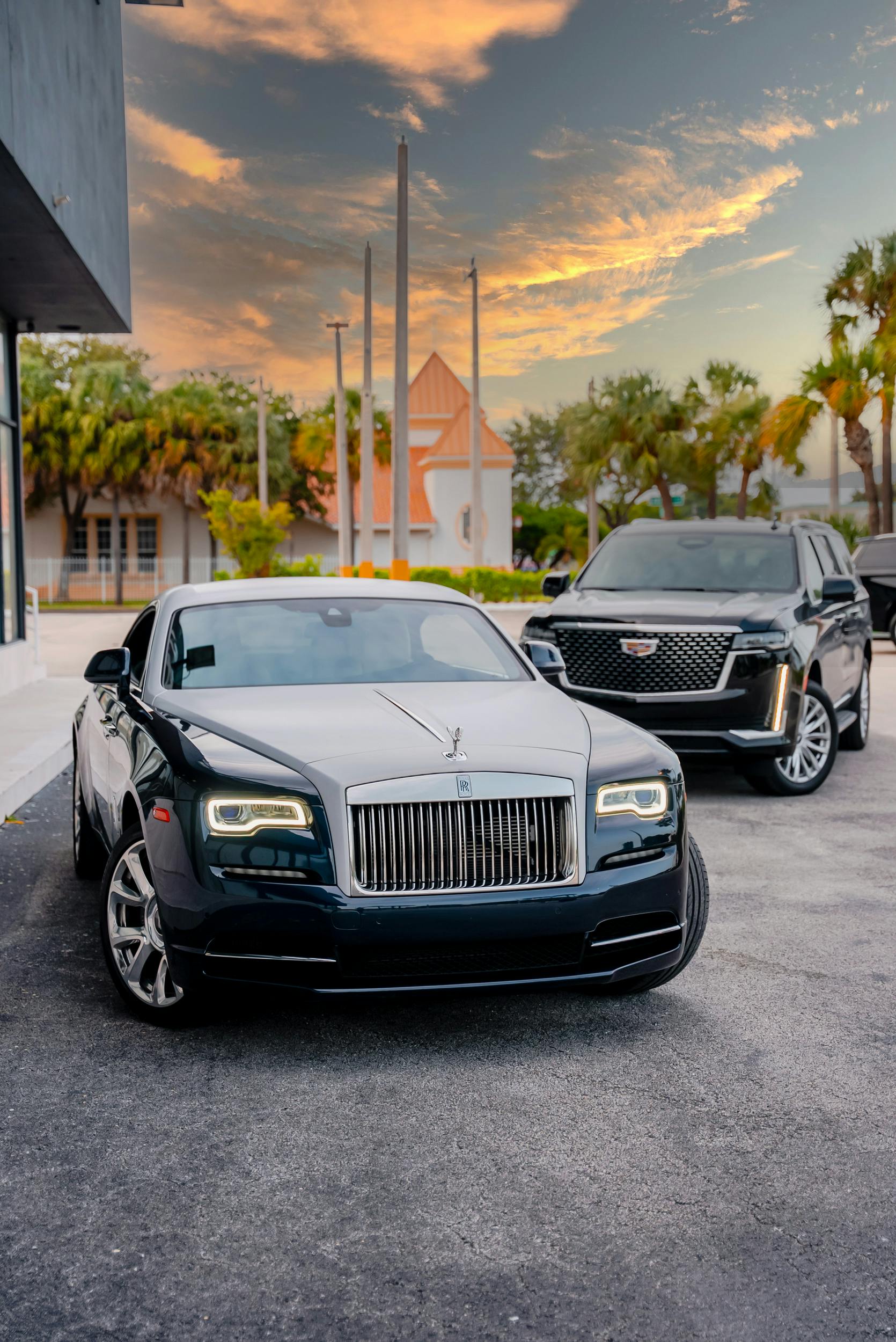 Luxury Rolls-Royce Wraith and Cadillac Escalade parked outdoors