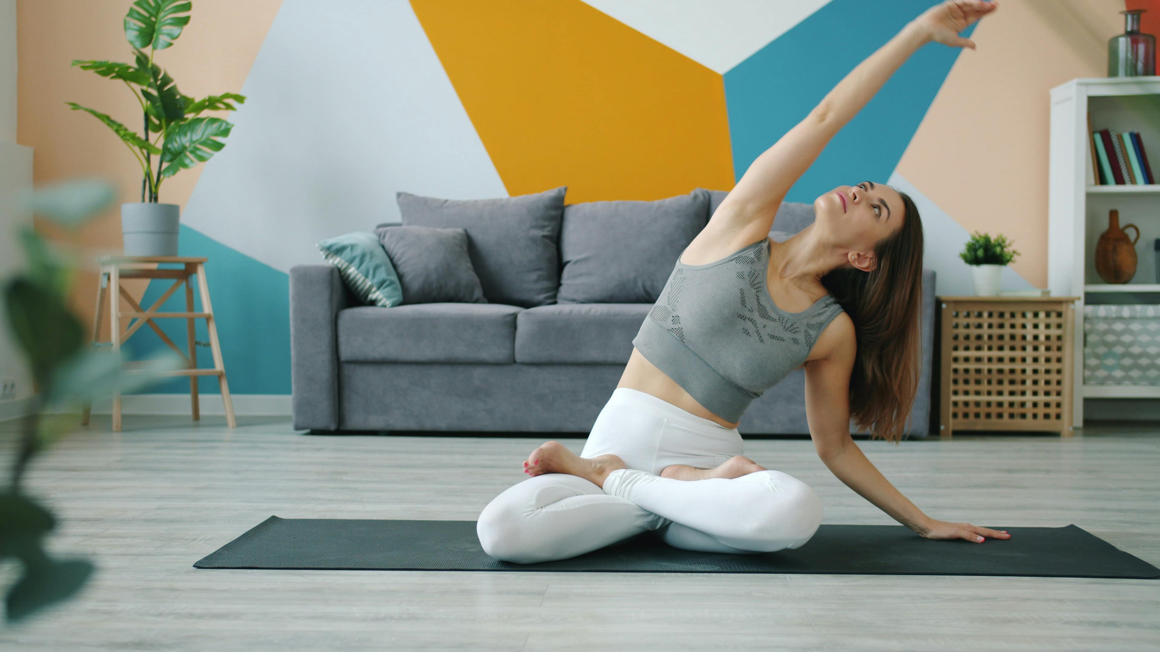 Woman doing yoga stretch in modern living room