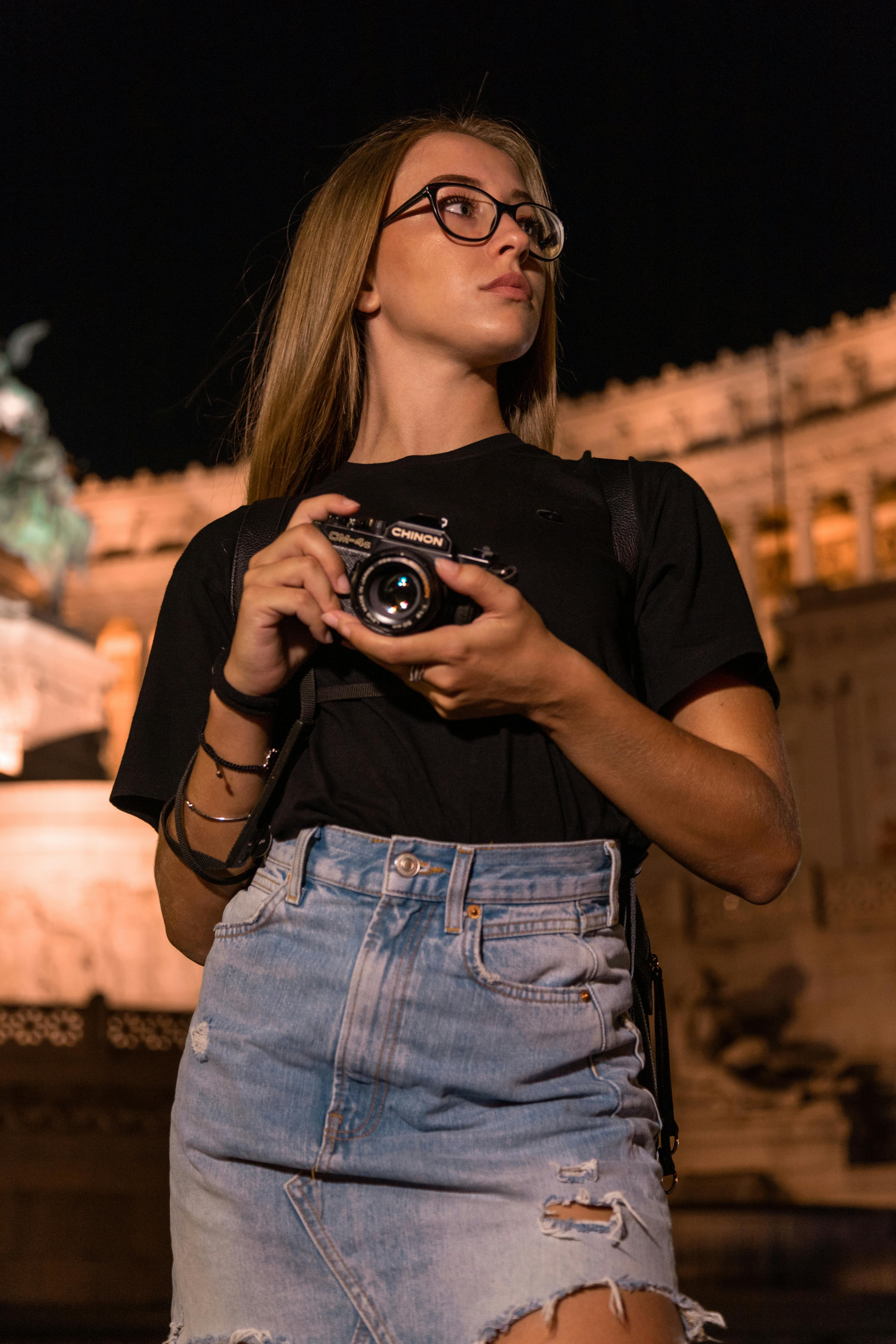 Young Woman Photographer with Vintage Camera at Night