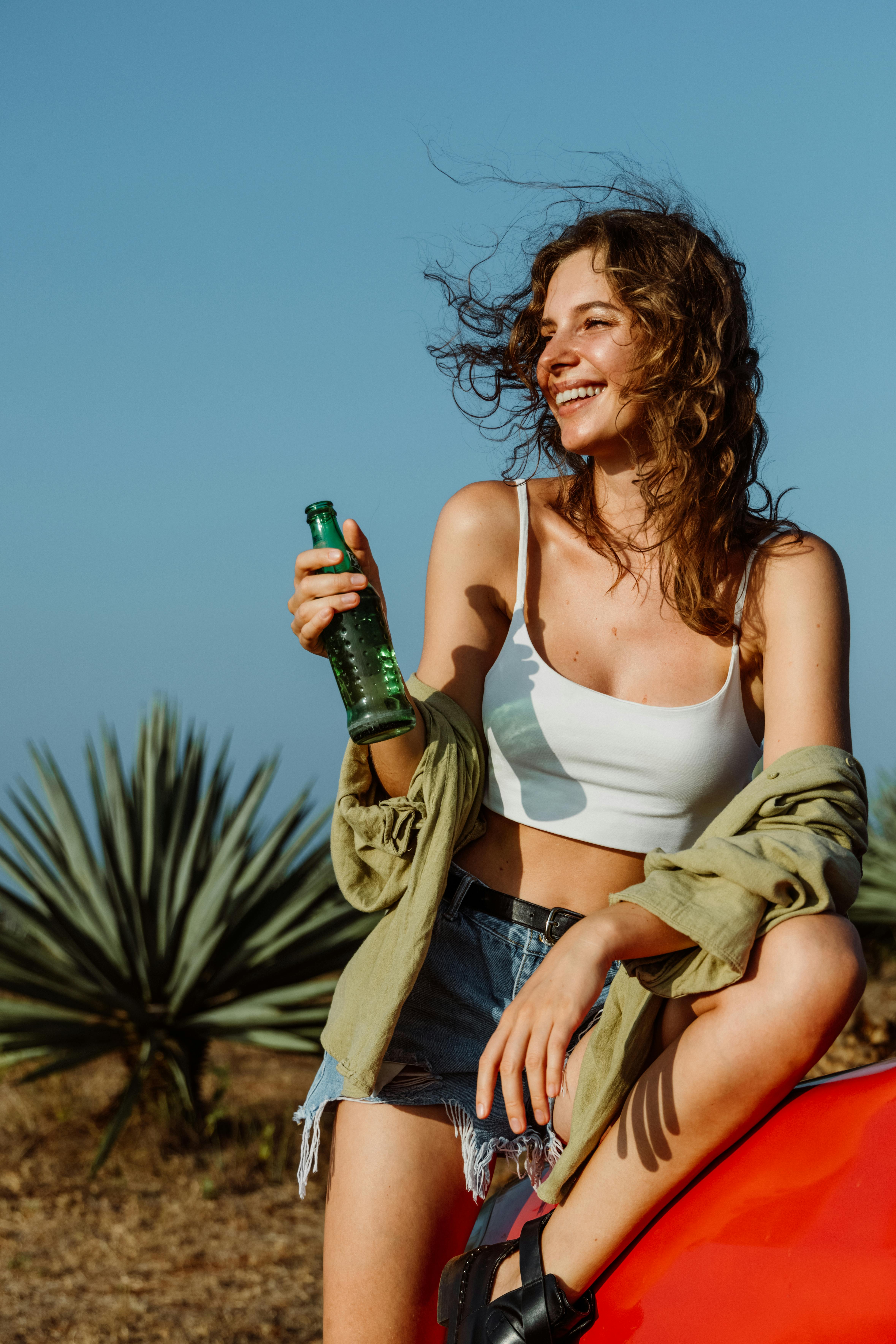 Happy Young Woman Enjoying Drink Outdoors