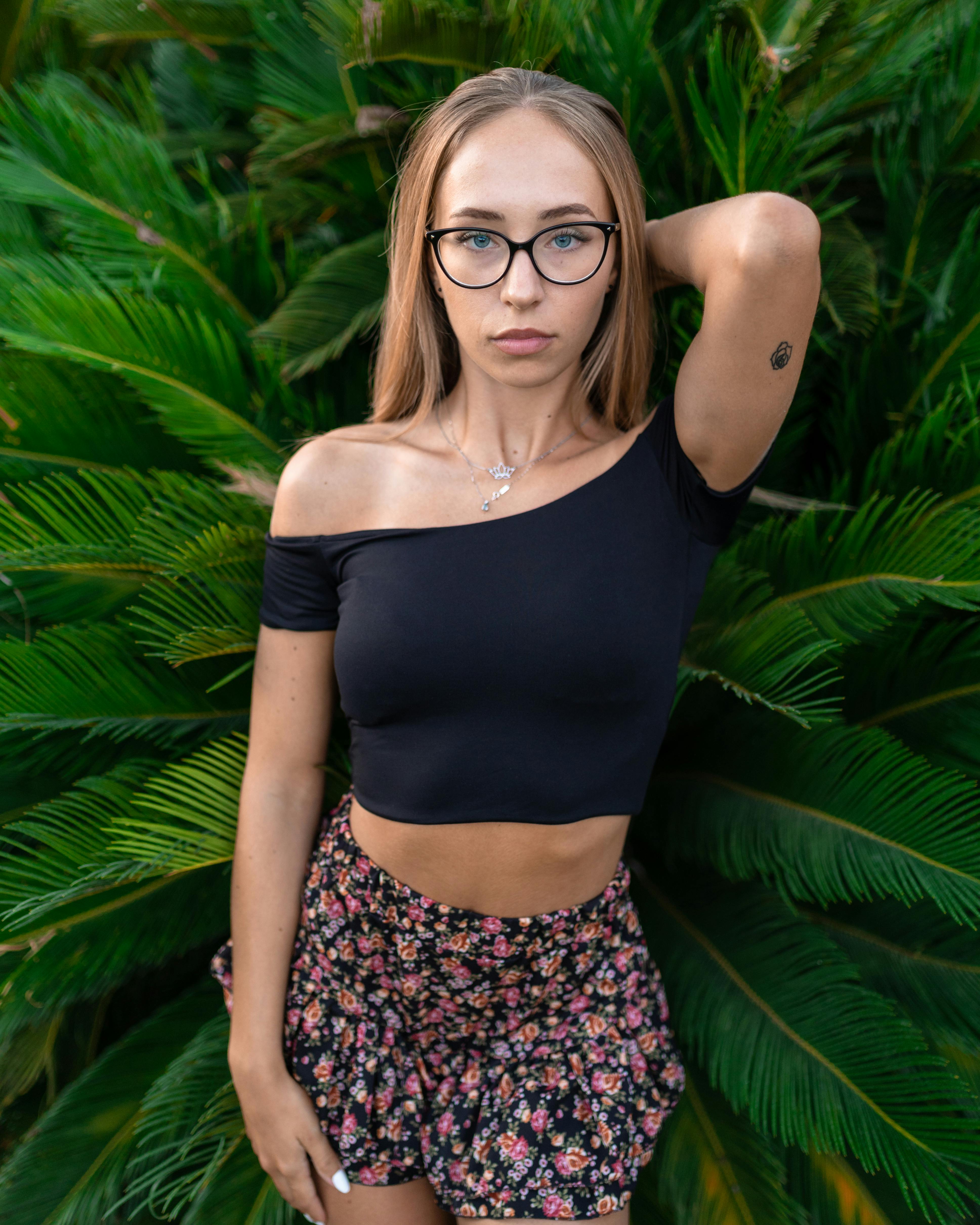 Young Woman Posing Against Lush Green Foliage