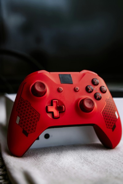 Vibrant Red Gaming Controller on Soft Fabric