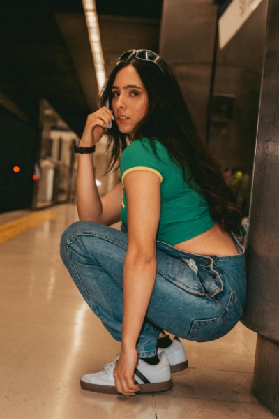 Young Woman Squatting on Subway Platform