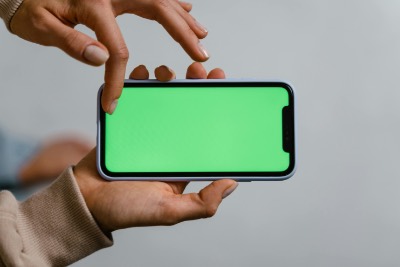 Hands Gesturing on Smartphone with Green Screen Mockup