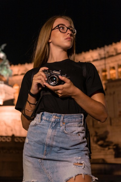 Young Woman Photographer with Vintage Camera at Night