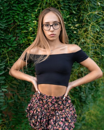 Young Woman in Glasses Posing Outdoors