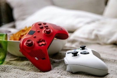 Red and White Gaming Controllers on Couch