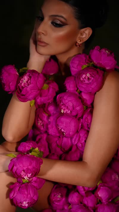 Woman Posing Artistically with Vibrant Pink Peonies