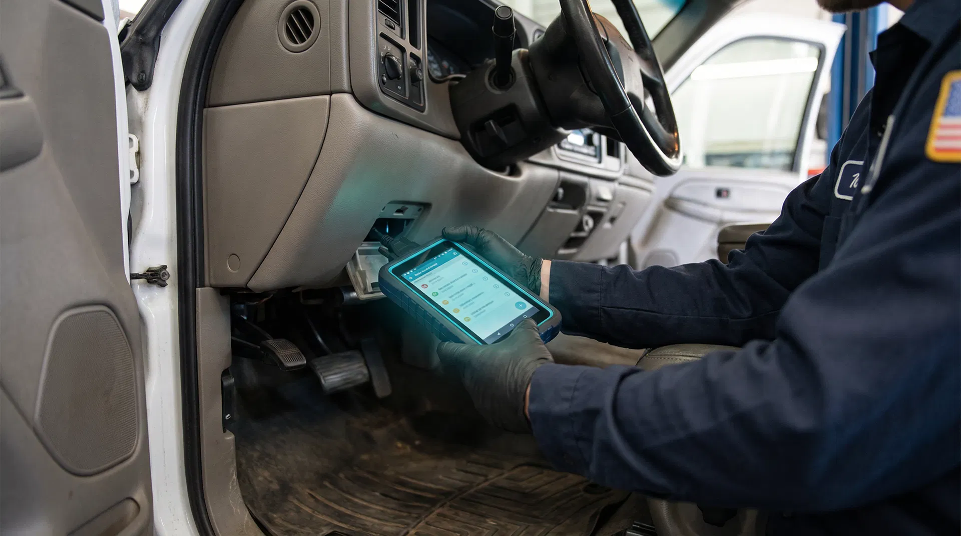 Technician performing vehicle diagnostics