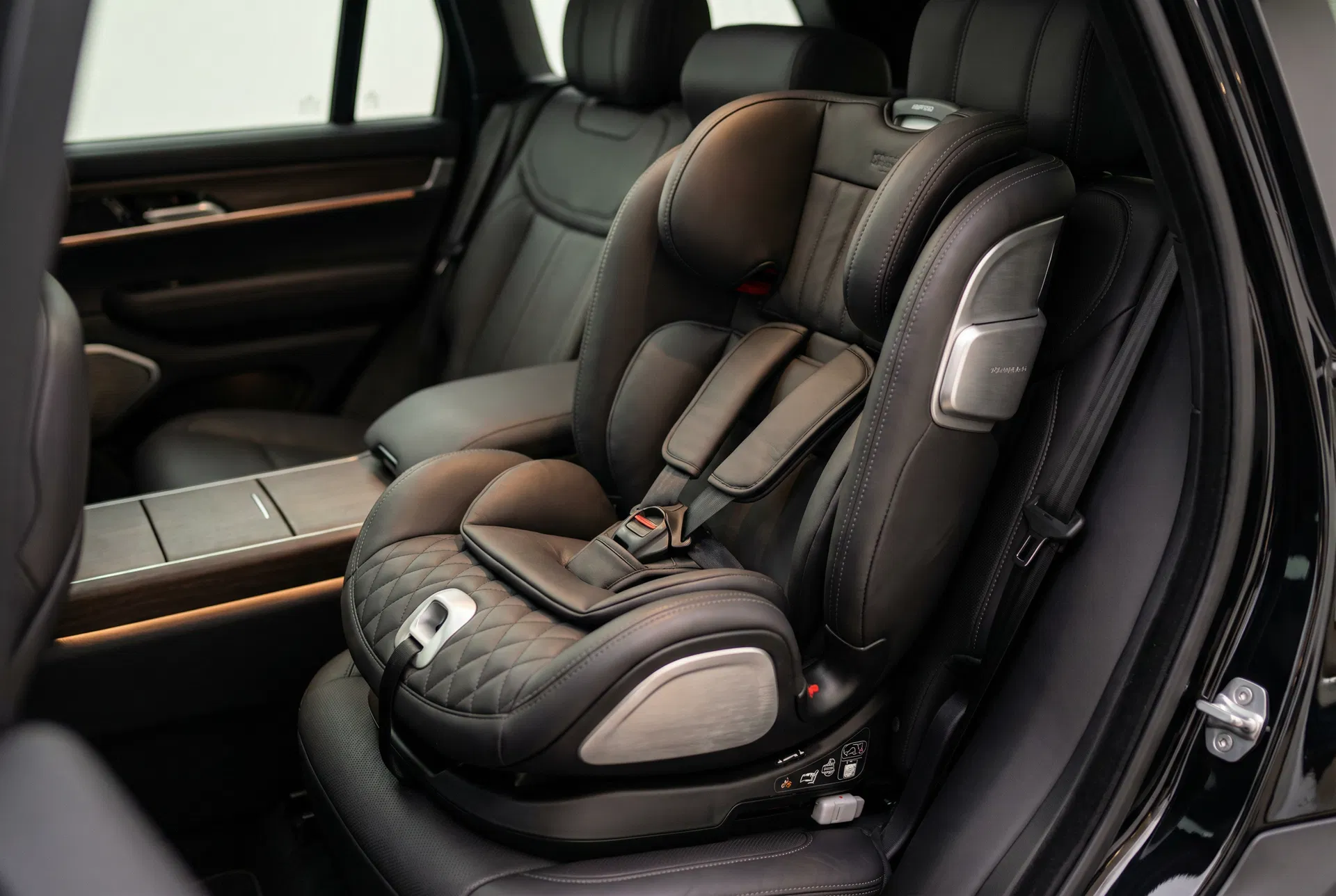 Premium child safety car seat installed in black Tahoe