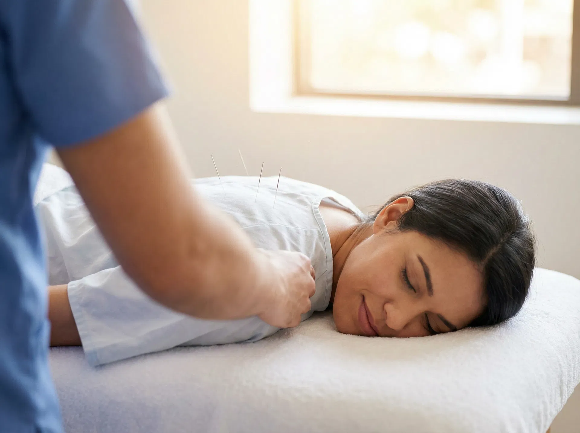 Woman receiving acupuncture treatment for fertility